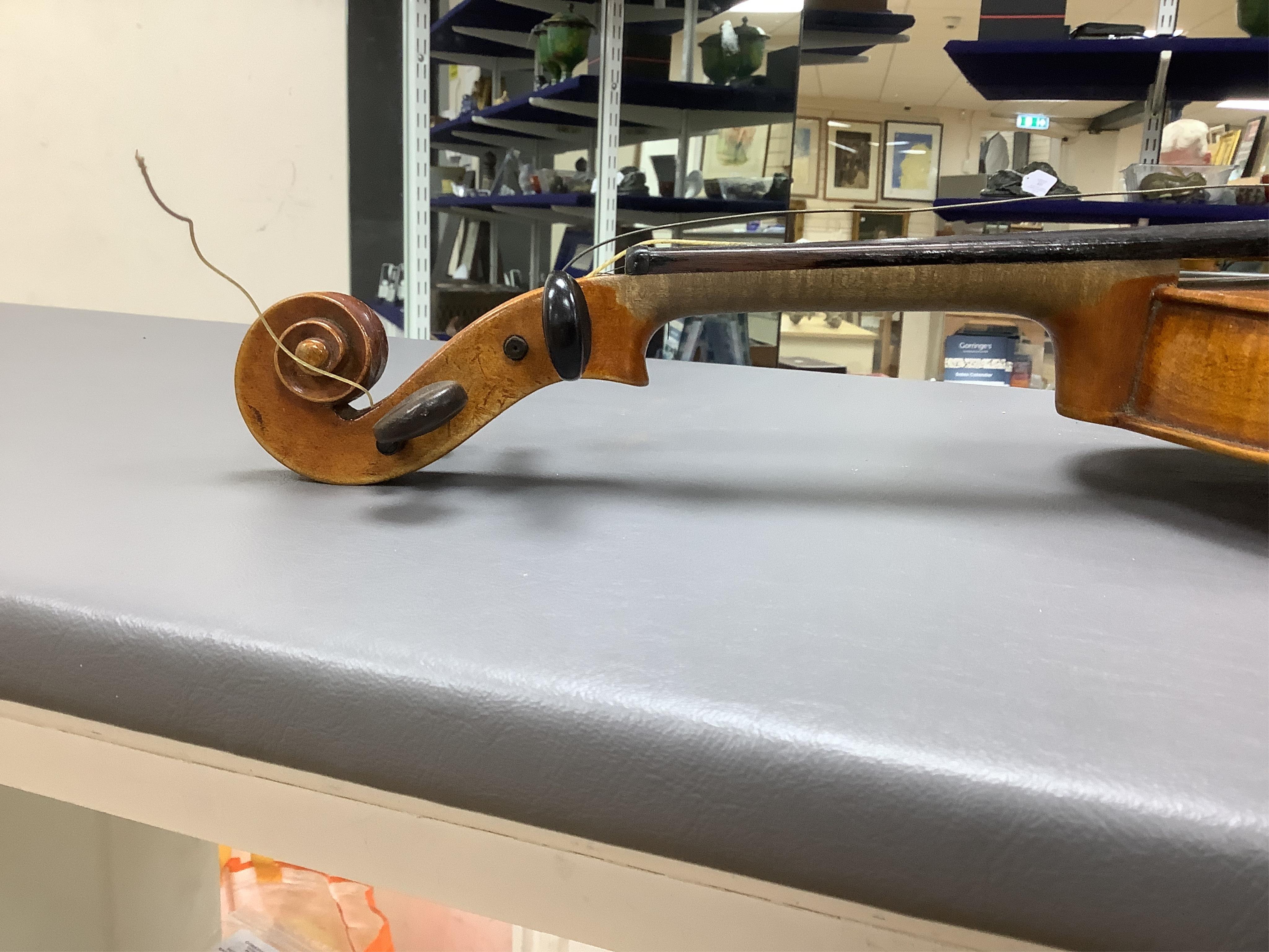 A cased full length violin, circa 1900, with bow, bears Stradivarius label to the interior. CITES Submission reference WVME8714